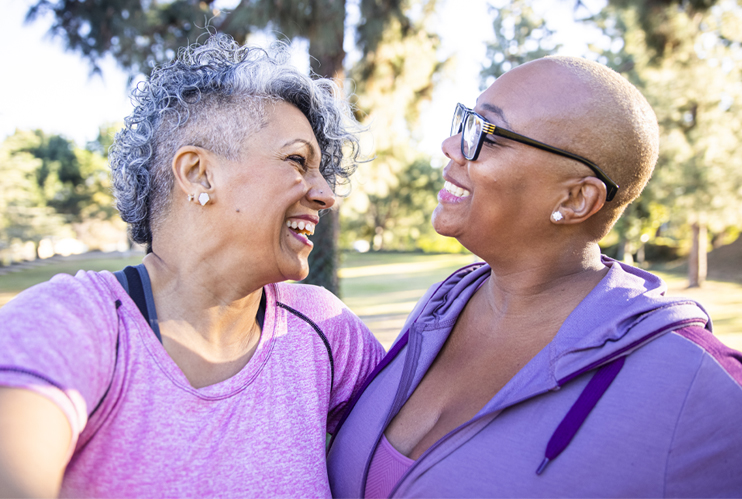 Image of two gay women smiling at each other.